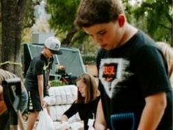 People putting sand in bags